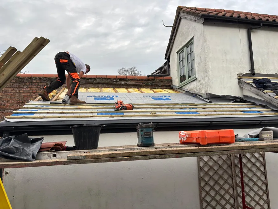 Roofer laying a new roof in Cambridgeshire